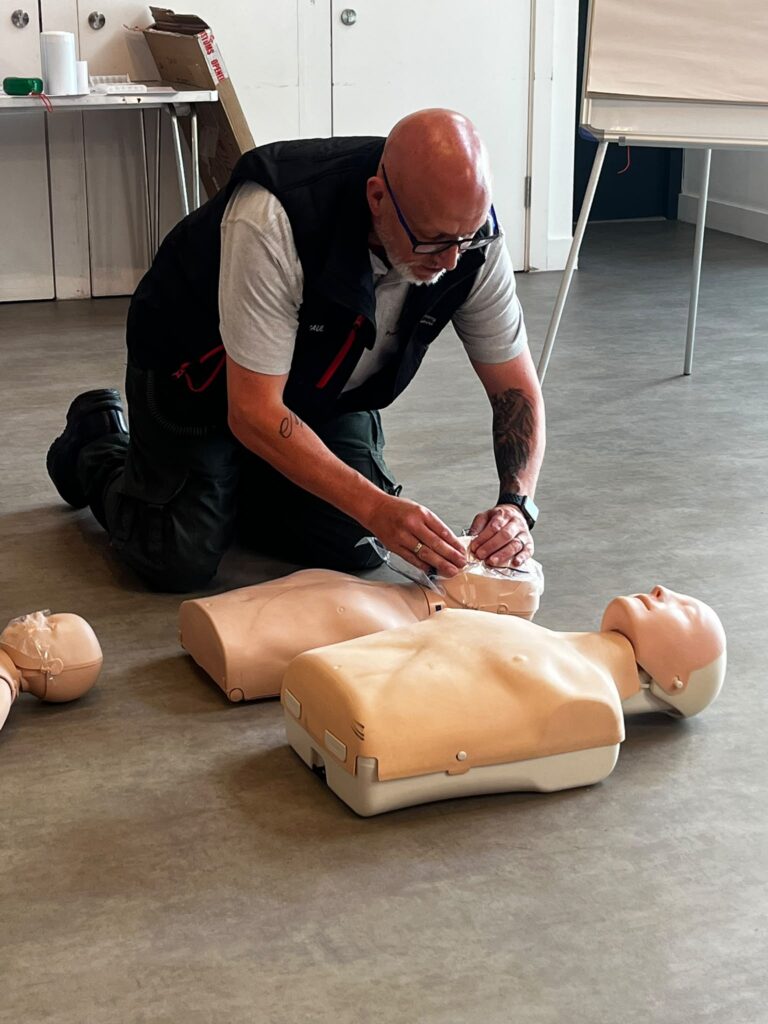 P3 First Aid Training instructor demonstrating AED use during practical first aid training